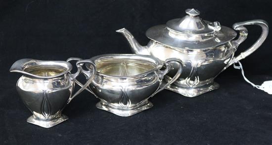 An Edwardian Art Nouveau three piece silver tea set by Elkington & Co, Birmingham, 1901, gross 22 oz.